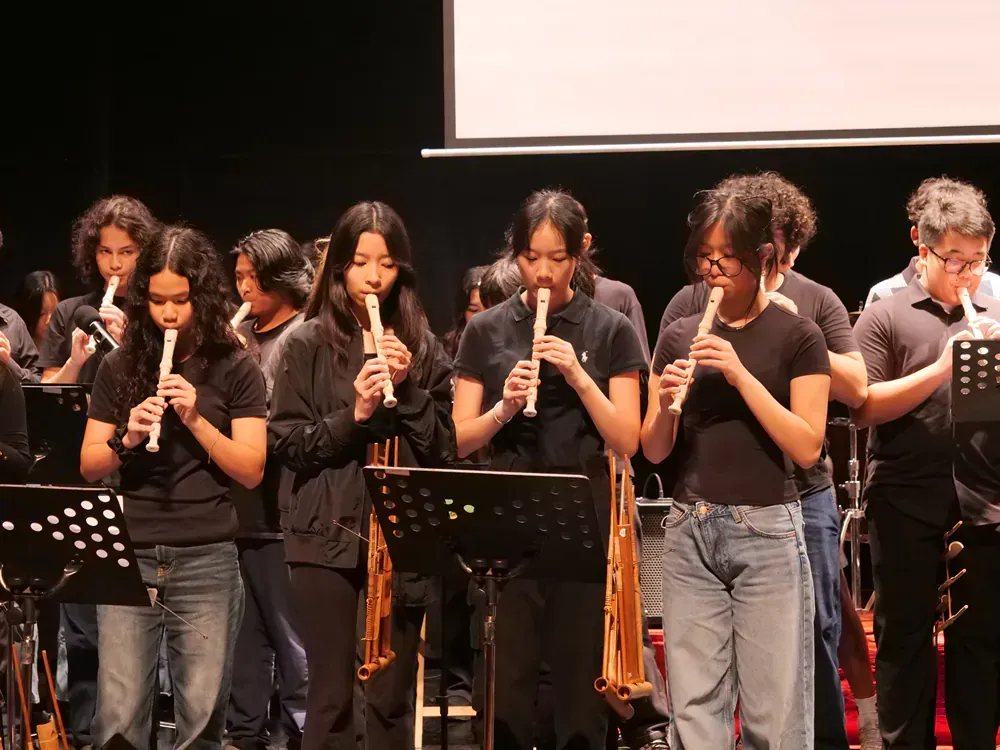 A group of people are playing instruments on a stage.