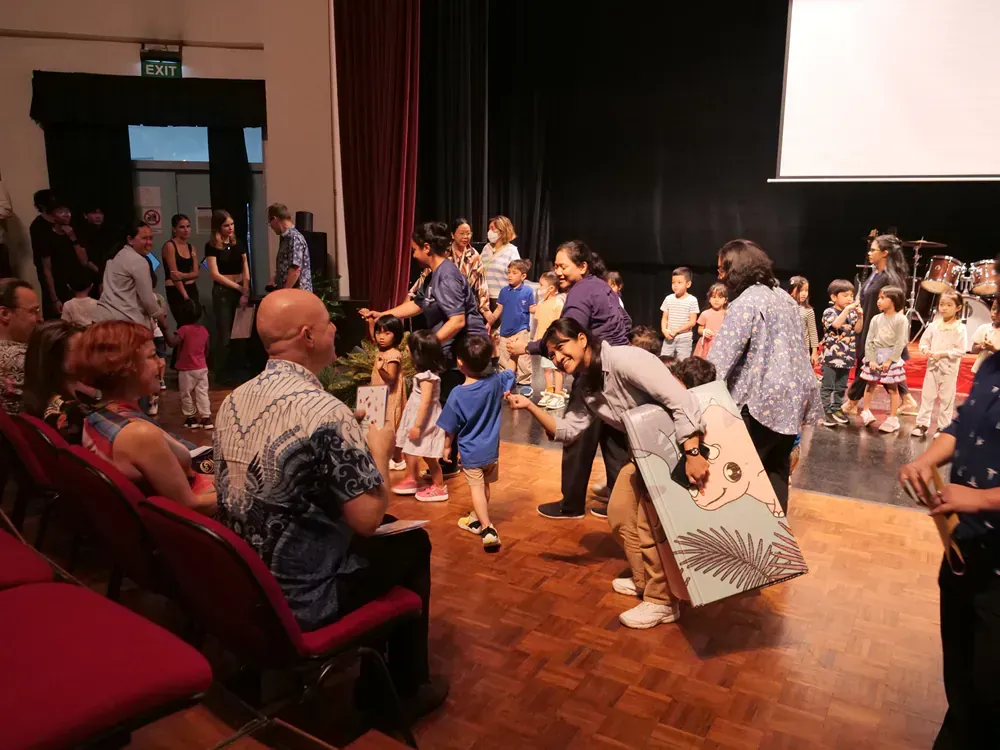 A group of people are playing a game on a stage.