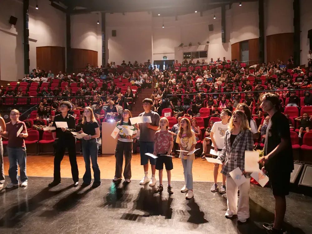 A group of people standing on a stage in front of a crowd