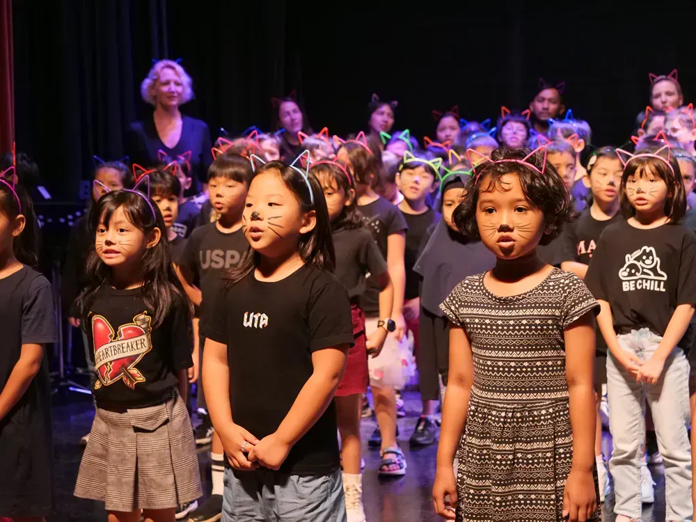 A group of young girls are standing on a stage.