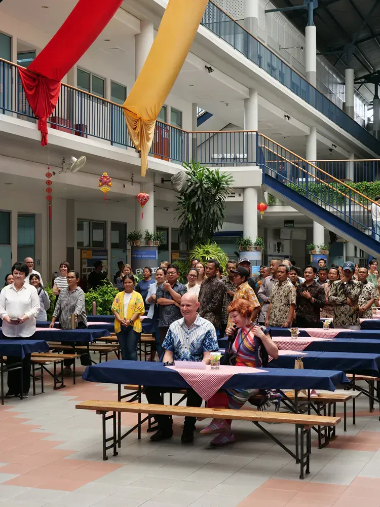 A group of people sitting at tables in a building