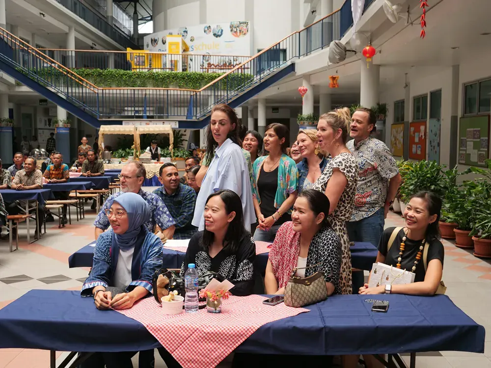 A group of people are sitting at tables in a building.