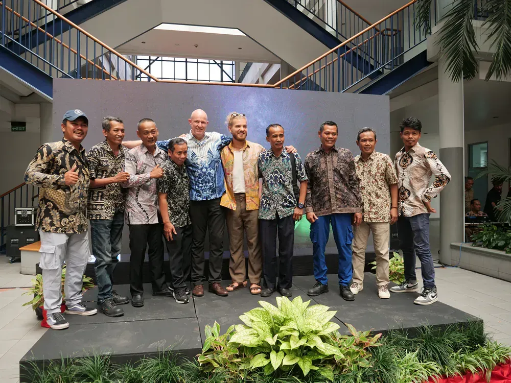 A group of men are posing for a picture on a stage
