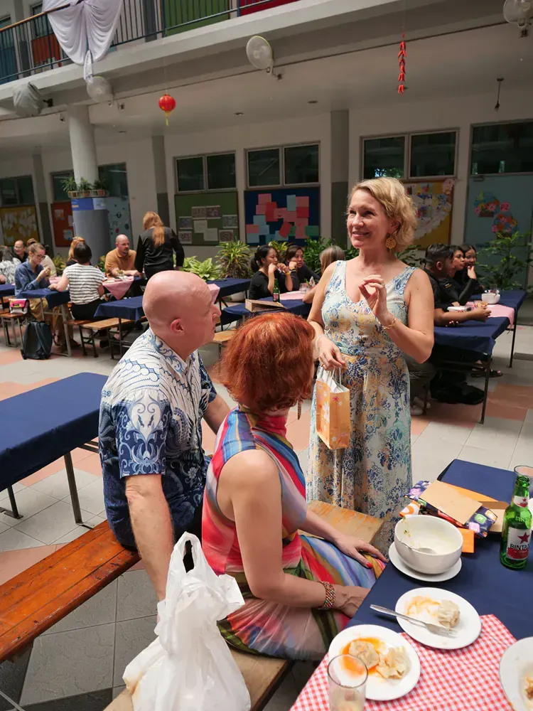 A man and a woman are sitting at a table with plates of food.