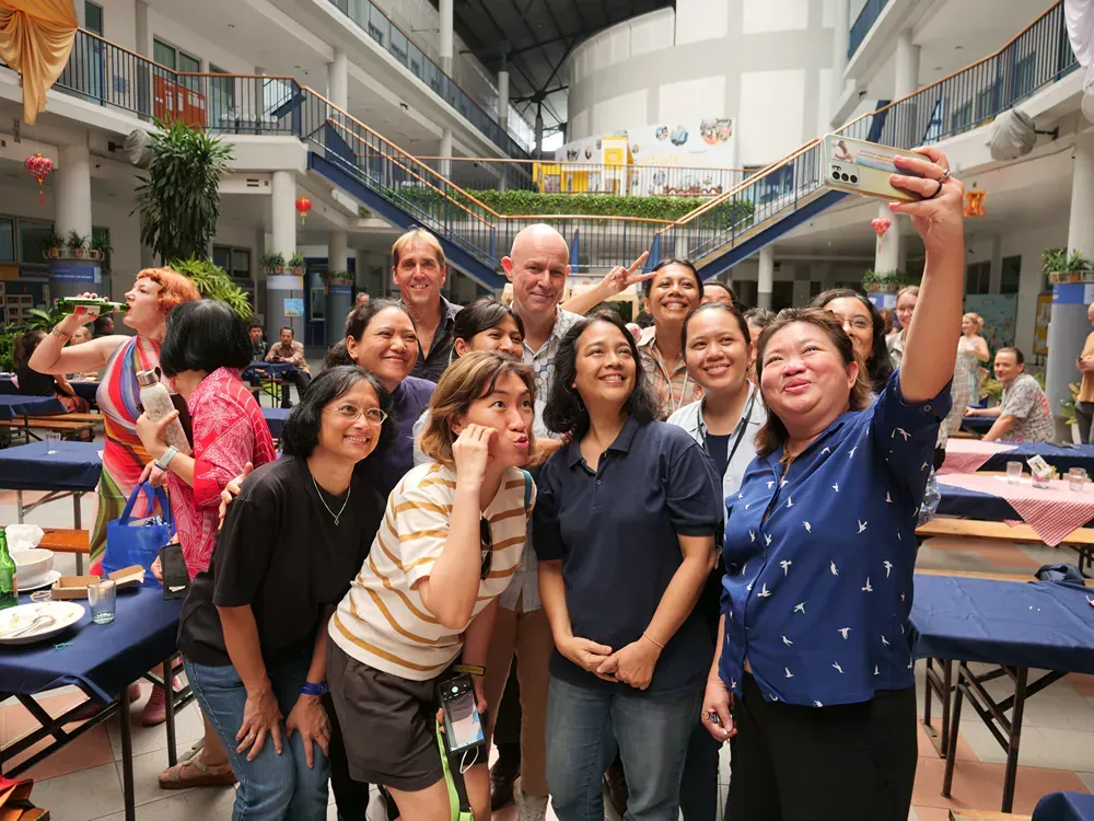 A group of people are posing for a picture in a building.
