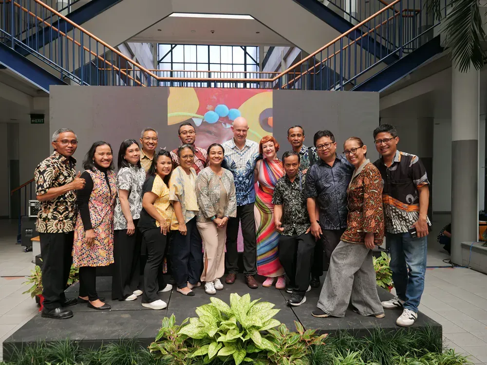 A group of people are posing for a picture in a building.