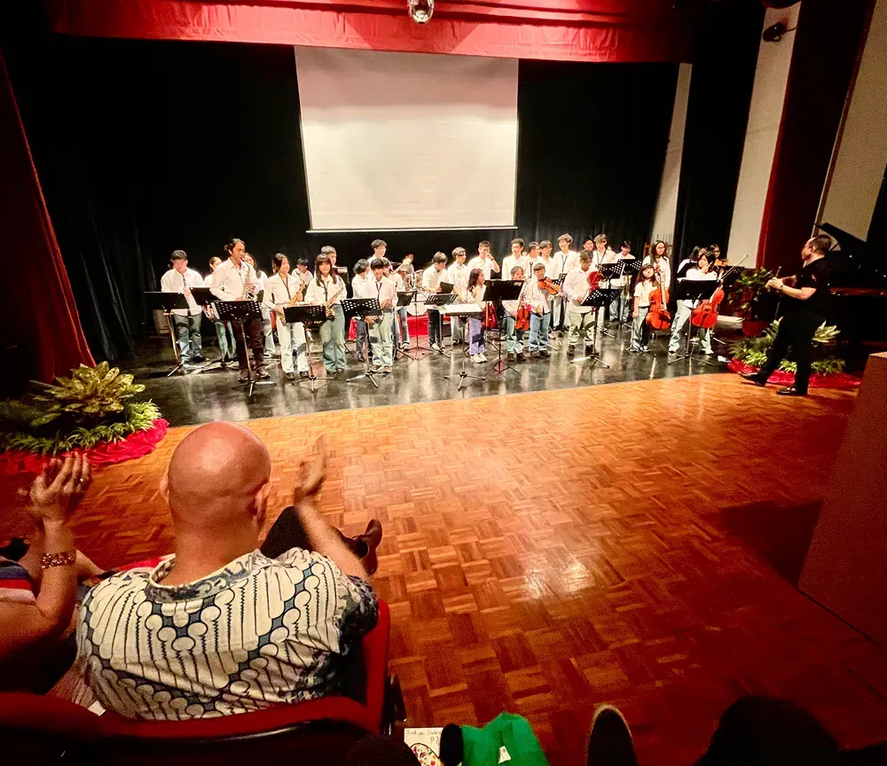 A man is watching a band perform on a stage