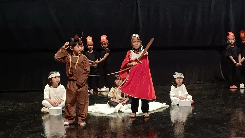 A group of children are performing on a stage.