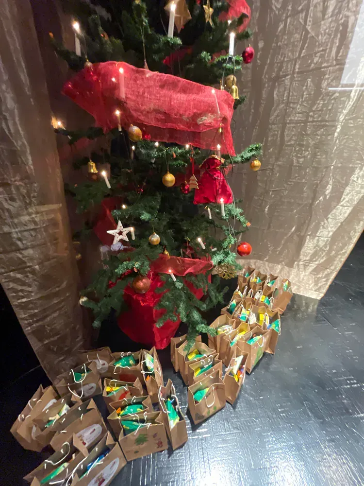 A christmas tree with lots of presents underneath it