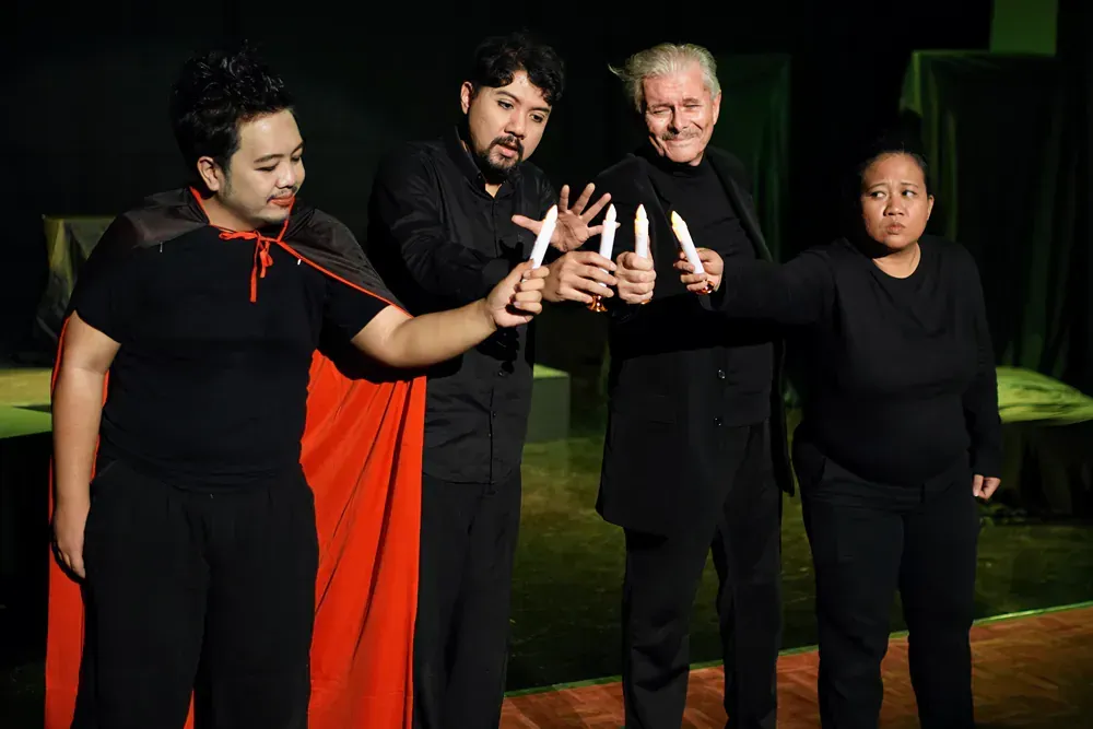 A group of people are holding candles in their hands.