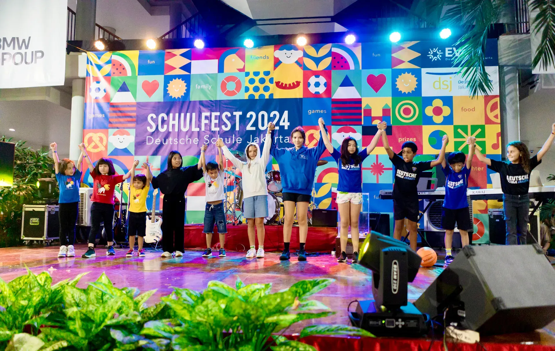 A large crowd of people enjoying the 2024 Schulfest in the Deutsche Schule Jakarta hall