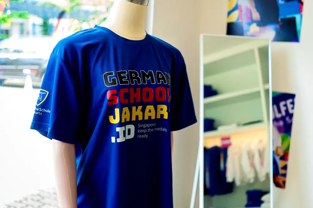 A blue german school t-shirt is on a mannequin