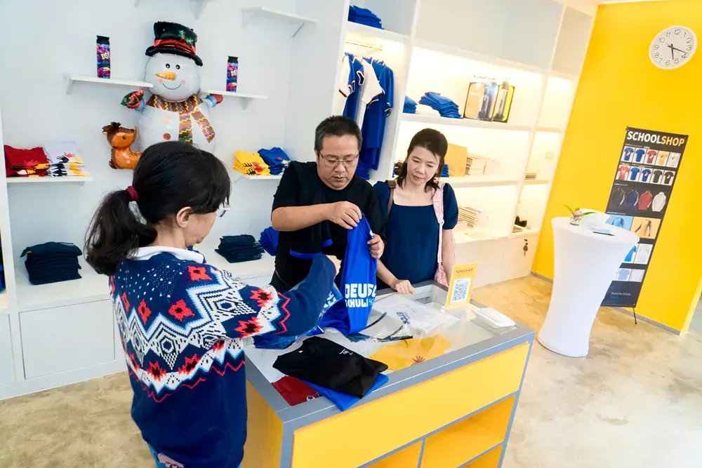 A group of people are standing around a counter in a store.