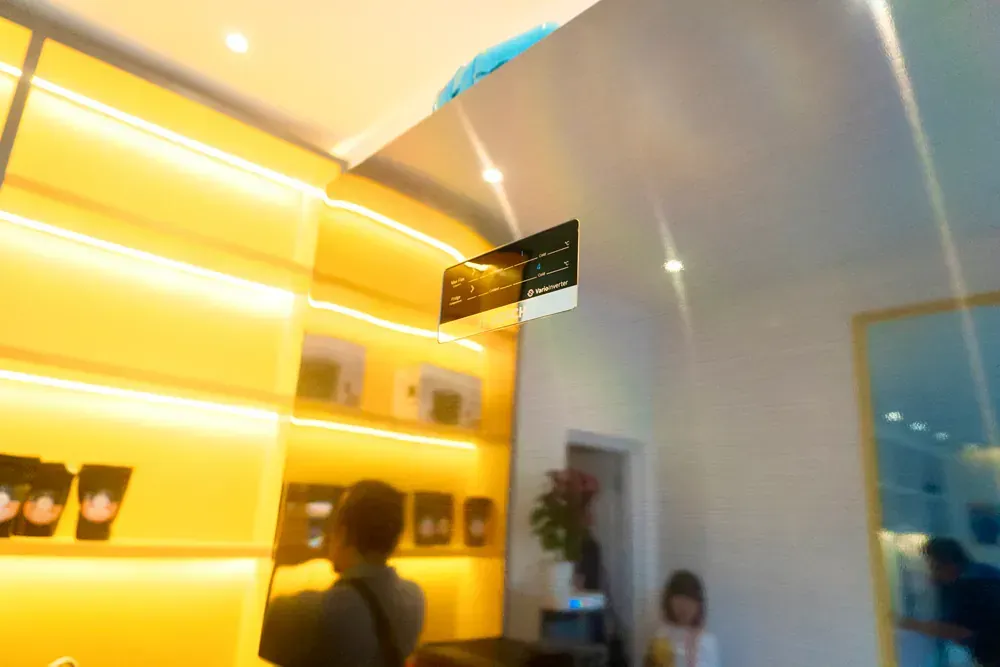 A blurry picture of a man standing in front of a yellow wall.