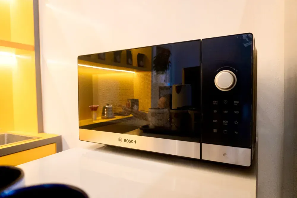 A microwave oven is sitting on a counter in a kitchen.