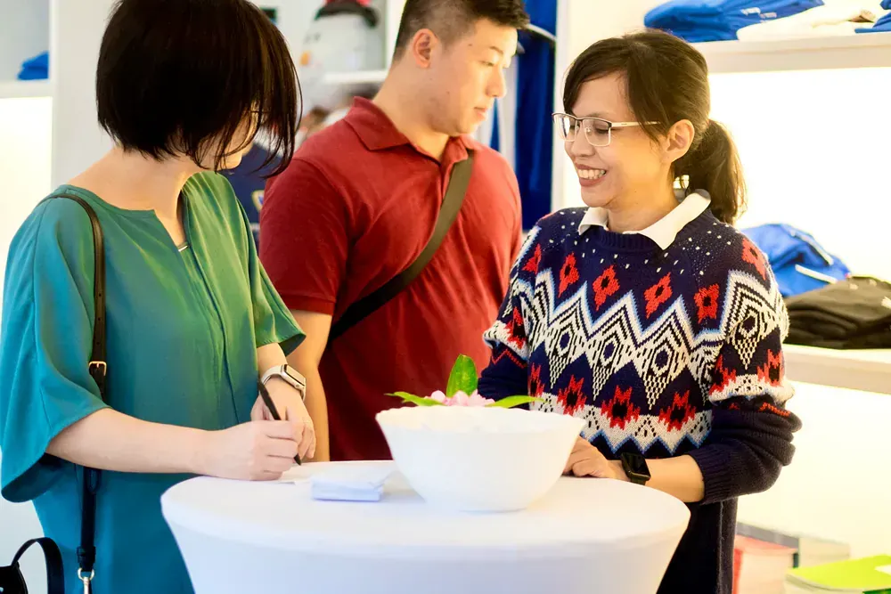 A group of people are standing around a table in a store.