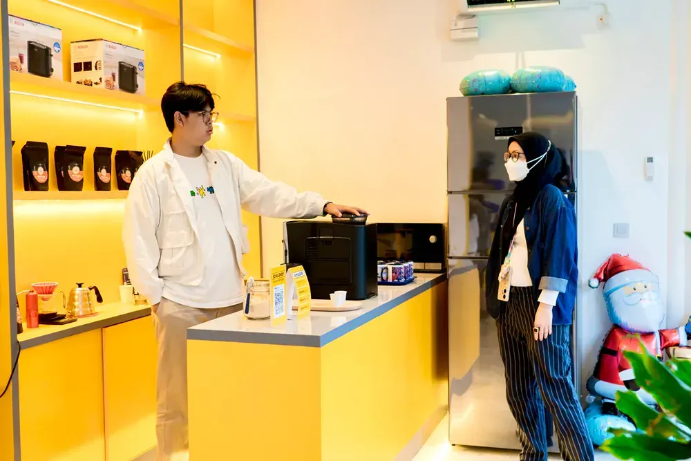 A man and a woman are standing next to each other in a kitchen.
