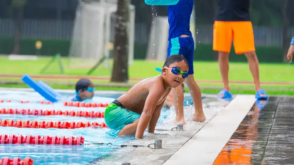 A group of children are playing in a swimming pool.