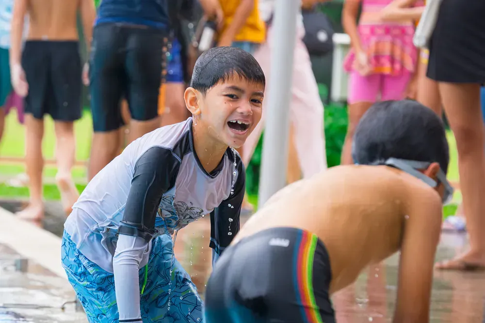 A group of children are playing in the water at a water park.