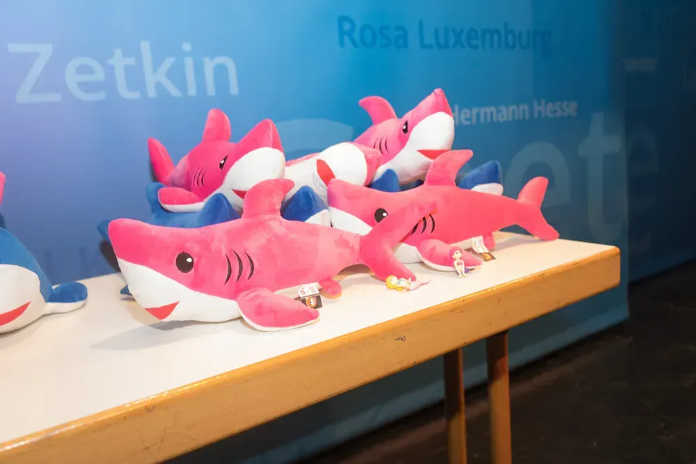 A bunch of stuffed sharks are sitting on a table