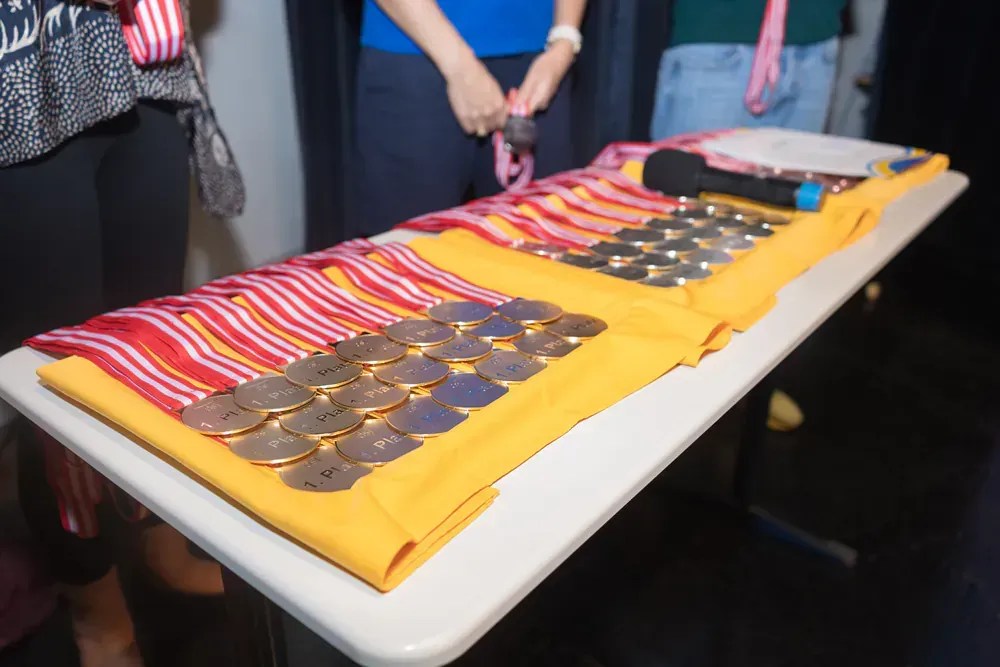 A table with medals and a microphone on it