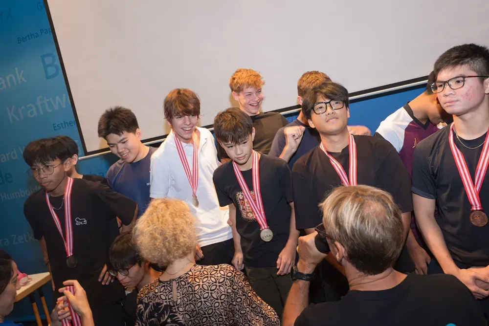A group of young men wearing medals are posing for a picture.