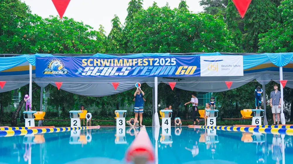 A swimming pool with a sign that says schwimmfest 2025 on it.