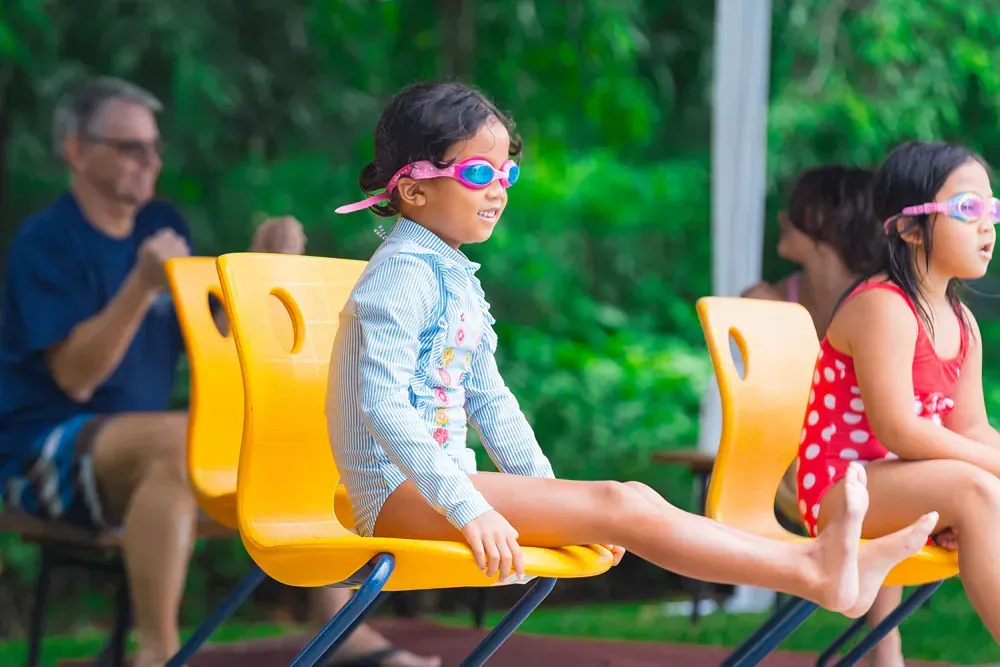 Young girls wearing swimming attires and googles.