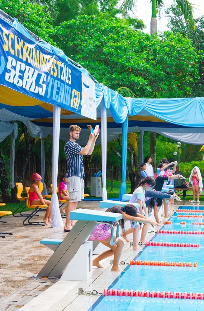A group of people are getting ready to swim in a pool.