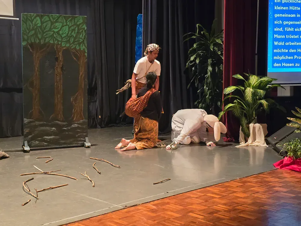 A group of people are playing a game on a stage.