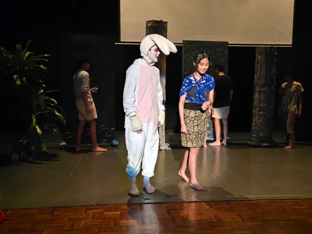 A man in a bunny costume is standing next to a woman on a stage.