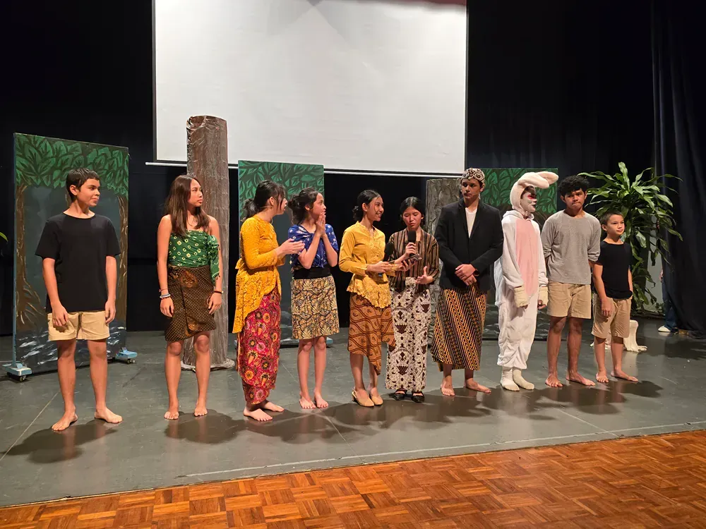 A group of people are standing on a stage.