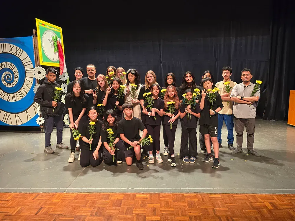 A group of people are posing for a picture on a stage.