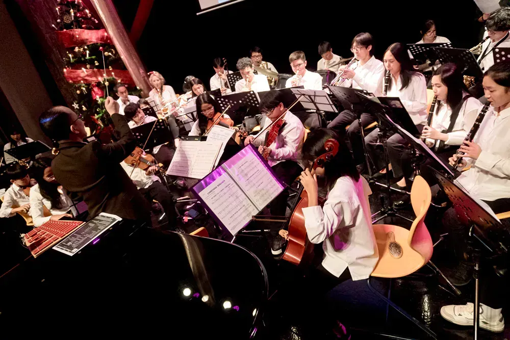 A group of people are playing instruments on a stage.