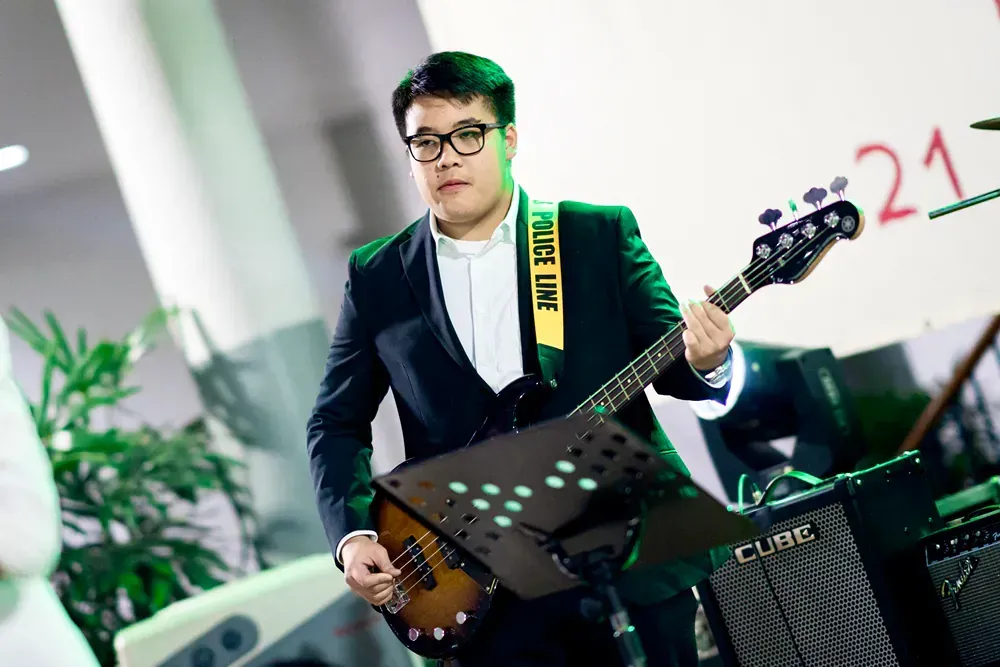 A man in a suit is playing a guitar.