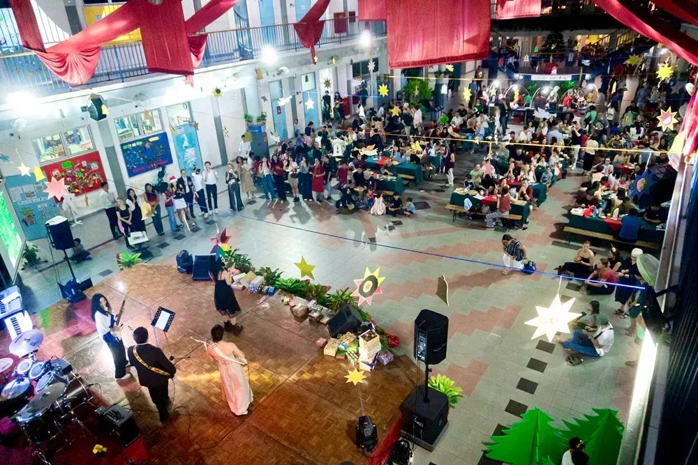 A large crowd of people are gathered in a large room.