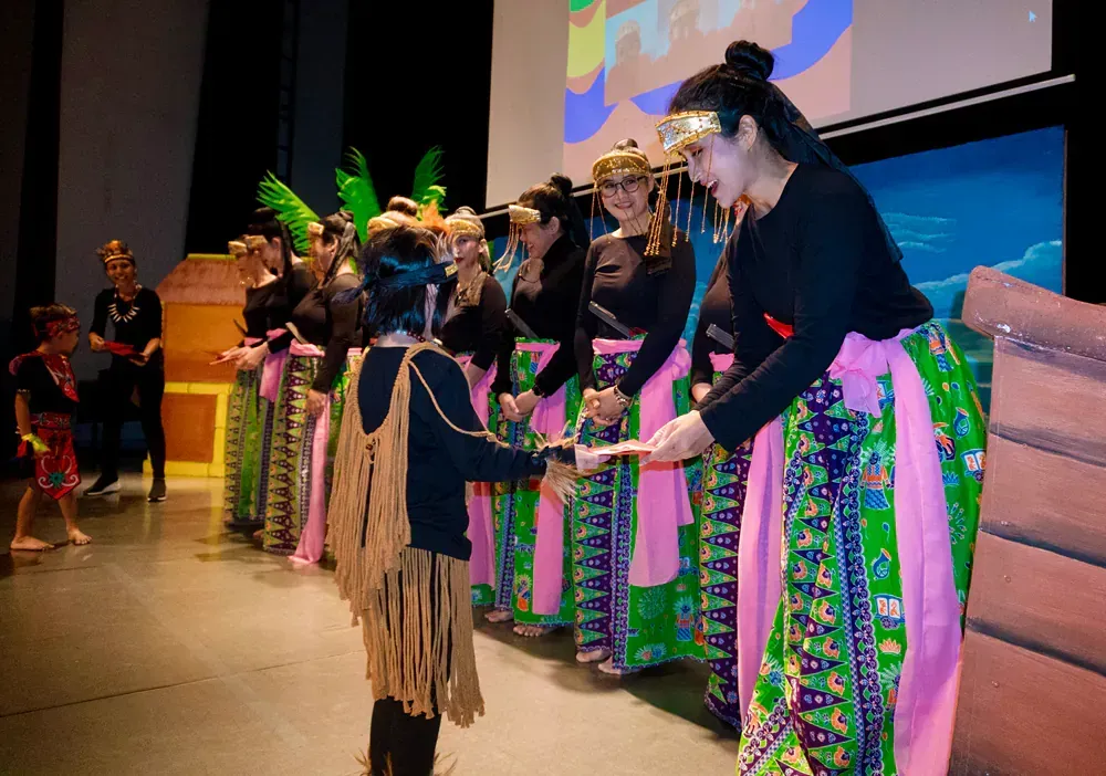 A group of people are standing in a line on a stage.
