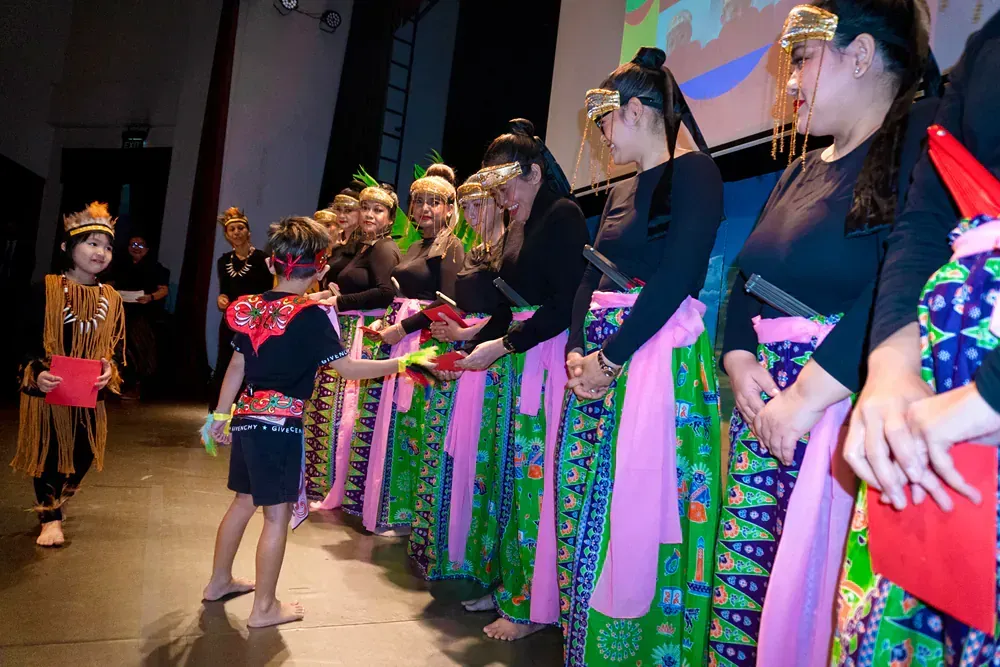 A group of people are standing in a line on a stage.