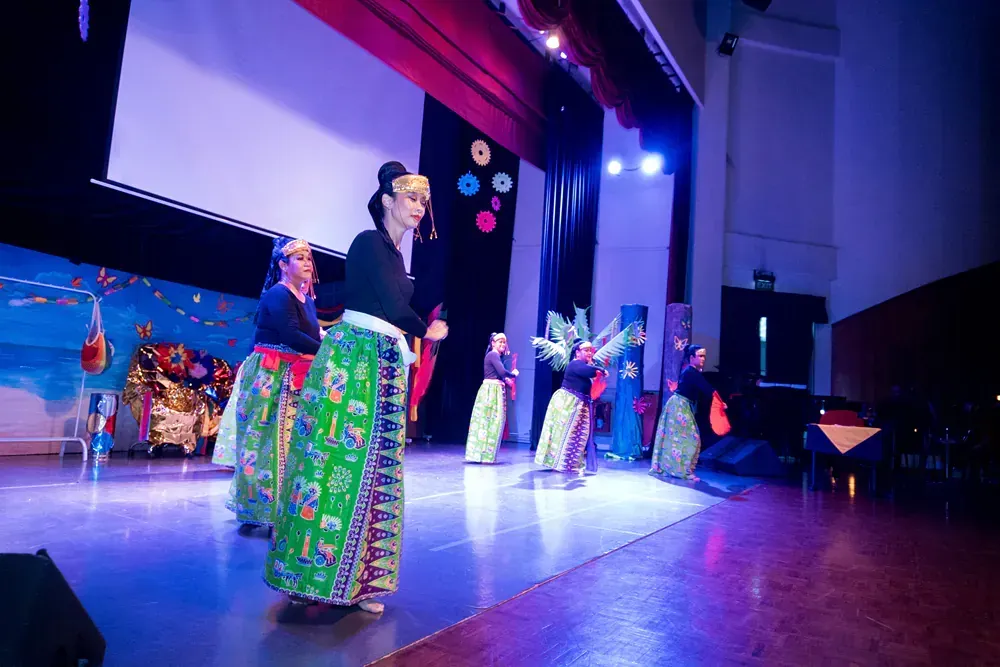 A group of people are dancing on a stage.