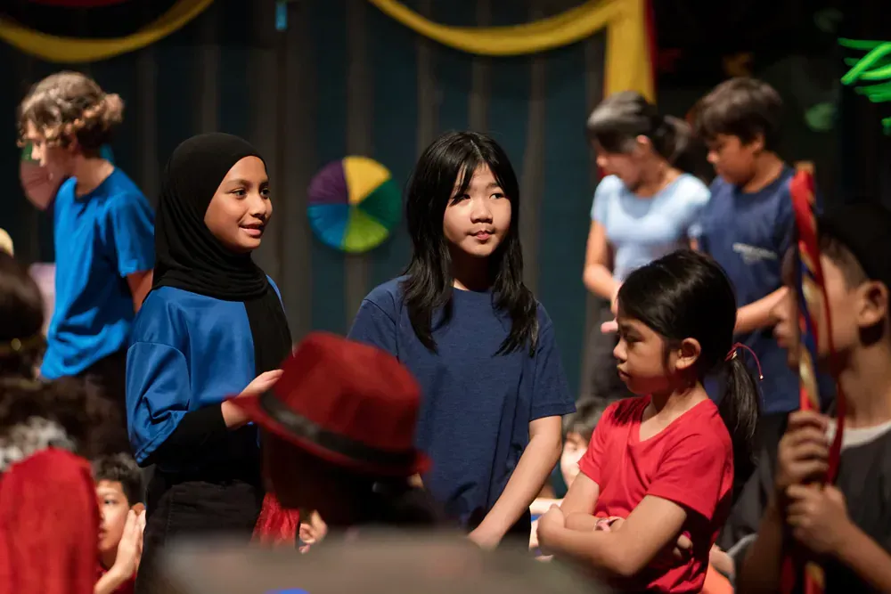 A group of children are standing on a stage.