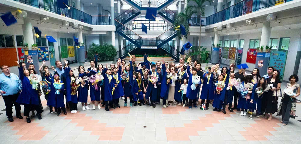 A large group of people are posing for a picture in a building.