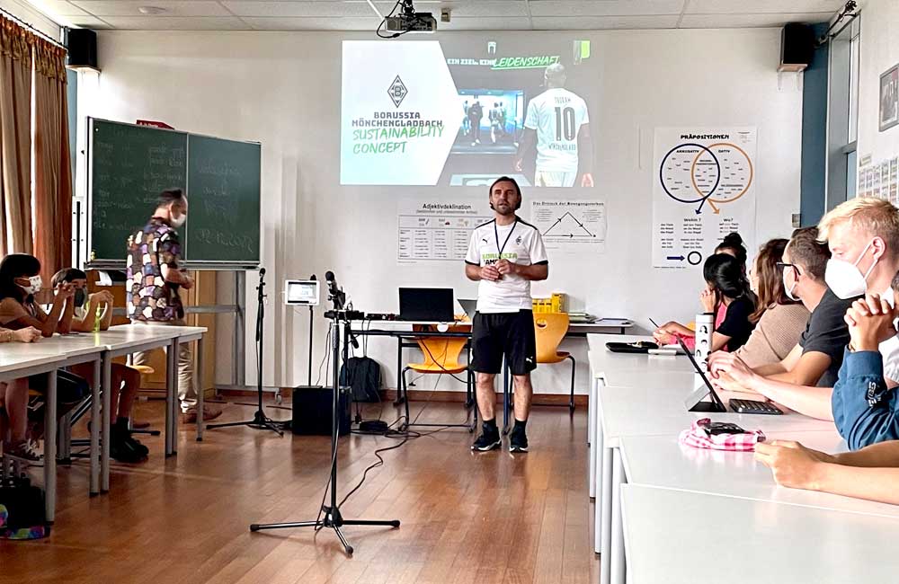 Borussia Mönchengladbach coach Wolfang Heilman lecturing students and teachers at the German School