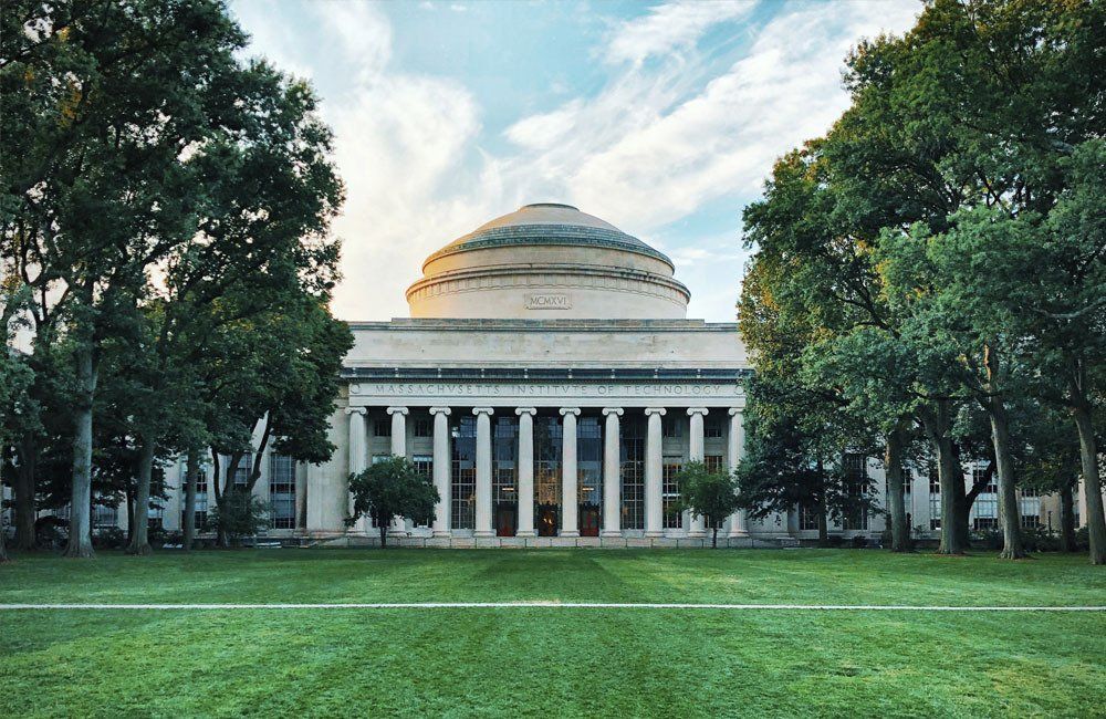 A large building with a dome on top of it is surrounded by trees.