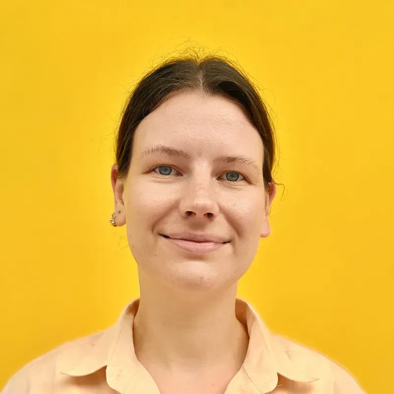 A man with gray hair is wearing a black shirt and looking at the camera.
