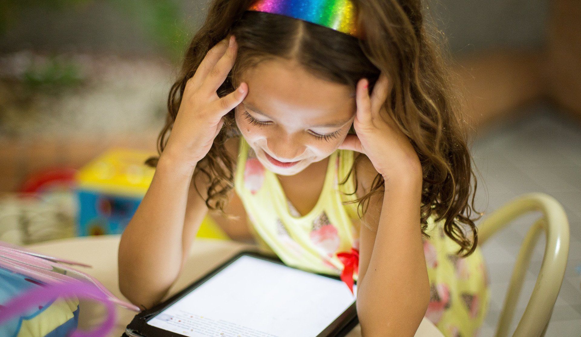 Young girl immersed into her tablet