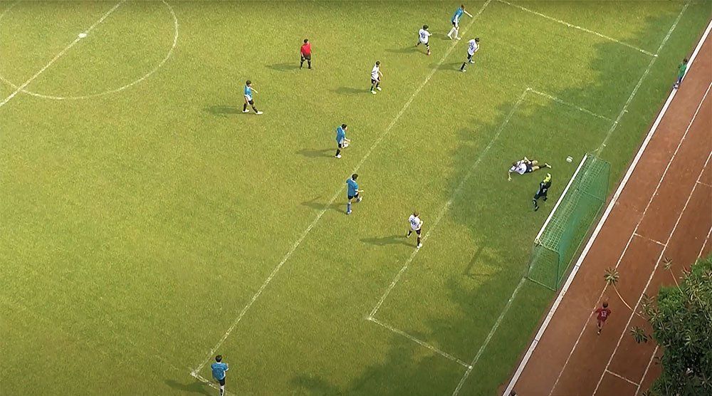 A group of people are playing soccer on a field.