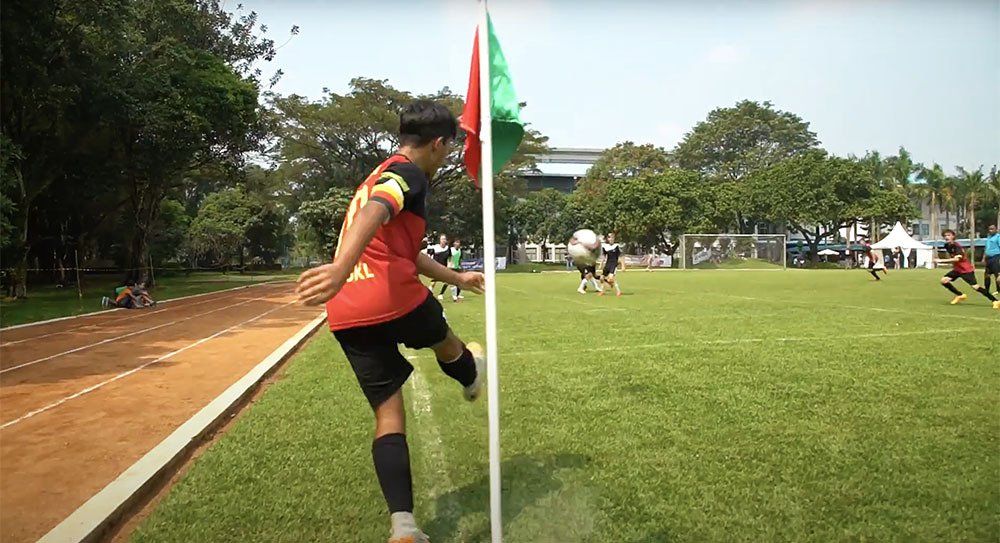 A student kicks a corner