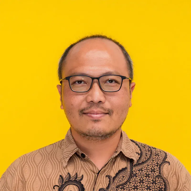 A man with a bald head is smiling for the camera.