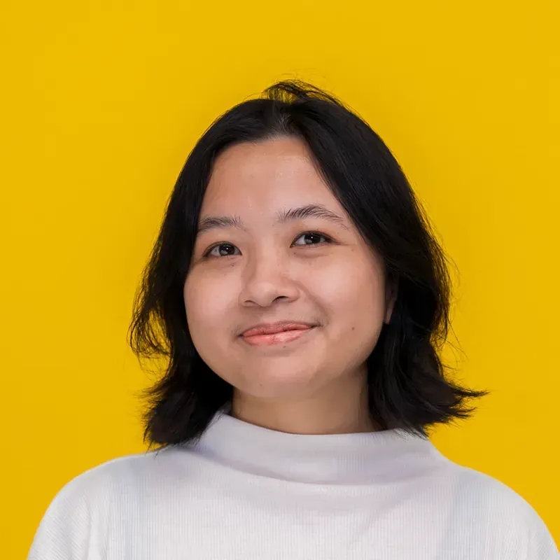 A young woman with short black hair is smiling for the camera.
