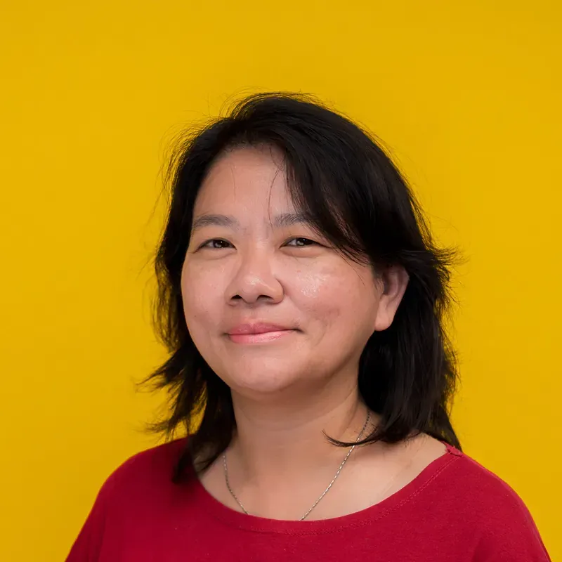 A close up of a woman 's face with a necklace around her neck